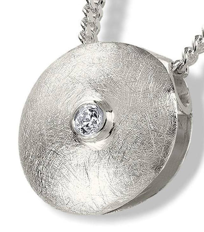 Ascheschmuck aus gebürstetem Material mit leuchtendem Stein
